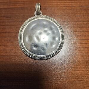 Silver toned round pendant jb